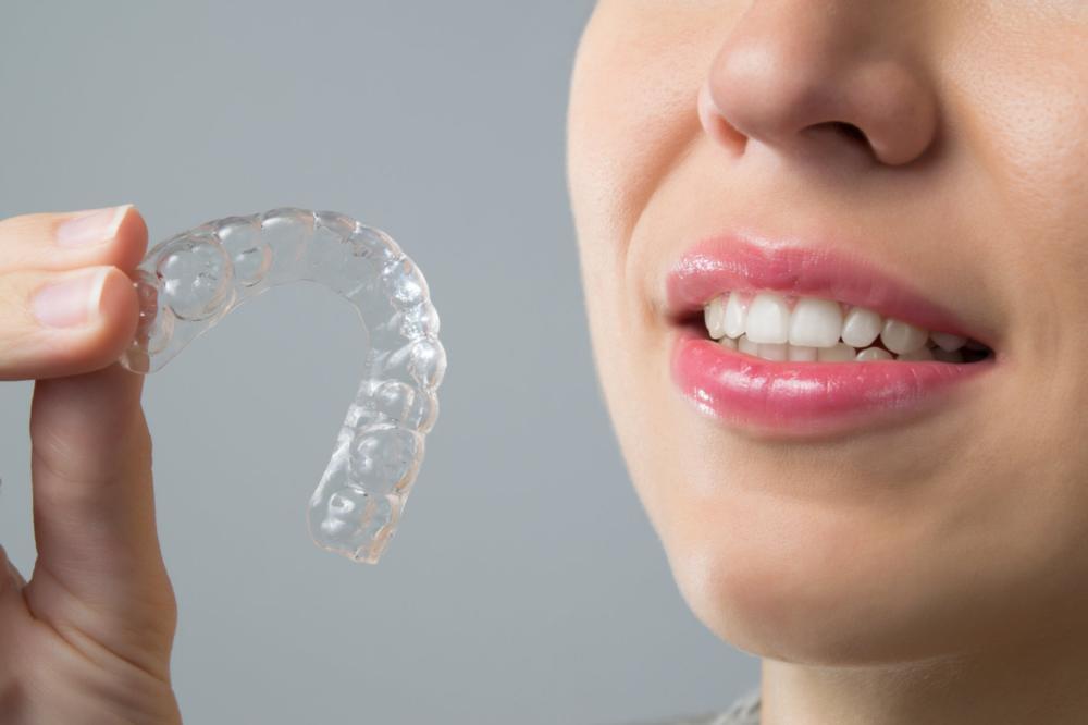 Woman holding Invisalign | Dentist Edmonton AB